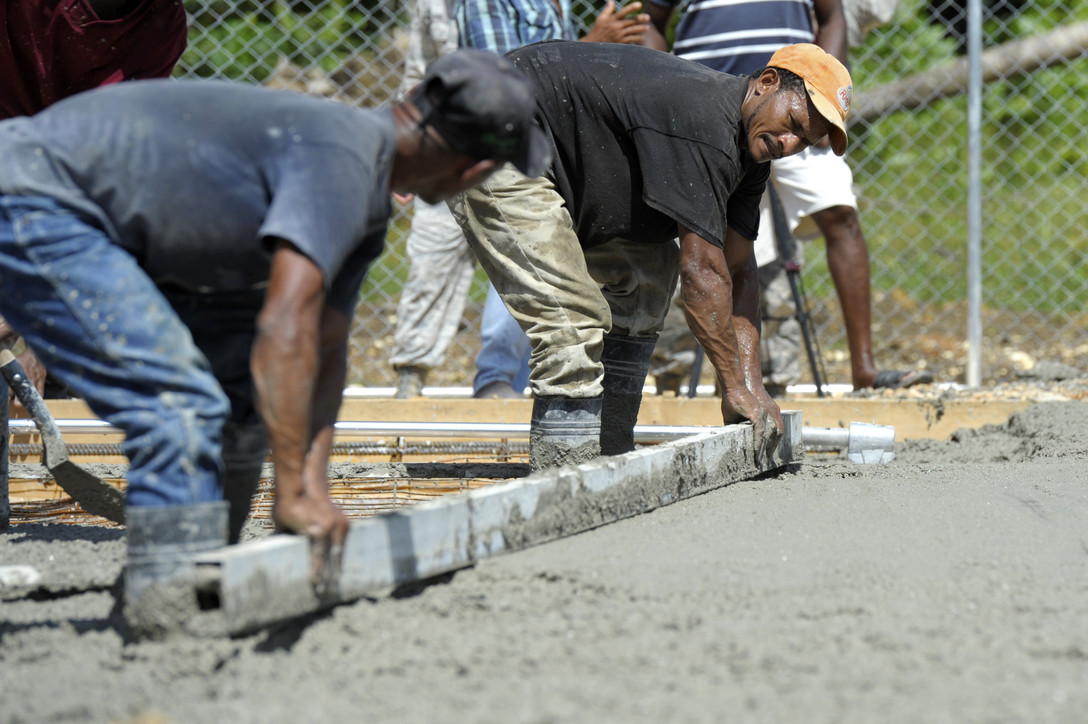 This is an image of a team of contractor smoothing out concrete.