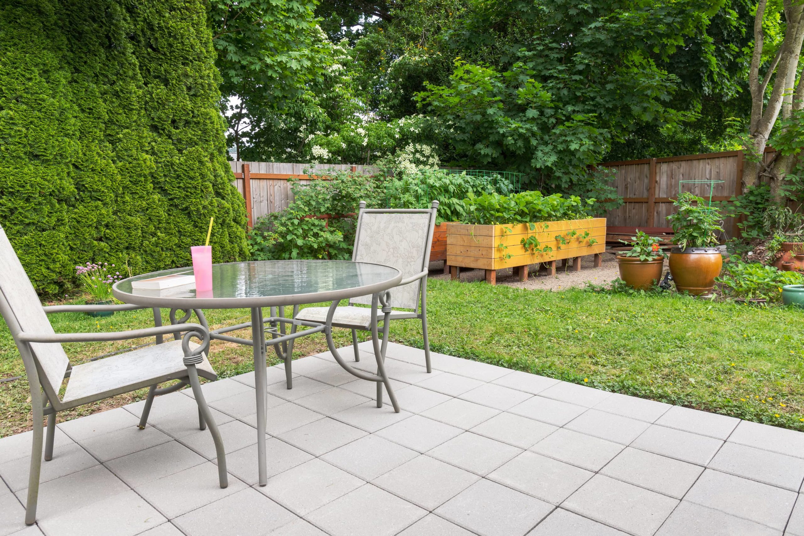 This is an image of a backyard concrete patio with stamped tile design.
