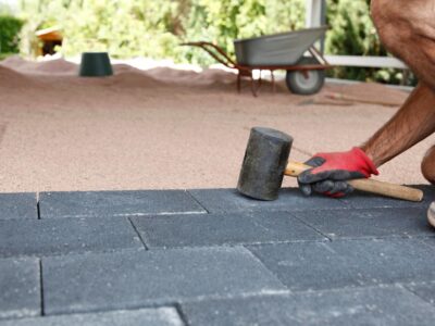 concrete paving installation This is an image of a contractor laying concrete paving bricks.
