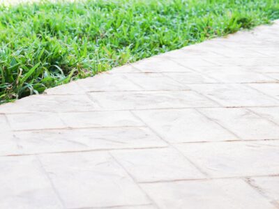 decorative stamped concrete This is an image of a concrete walkway with brick stamp design.