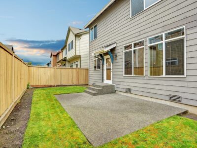 concrete patio builder This is an image of a simple rectangular backyard concrete patio.